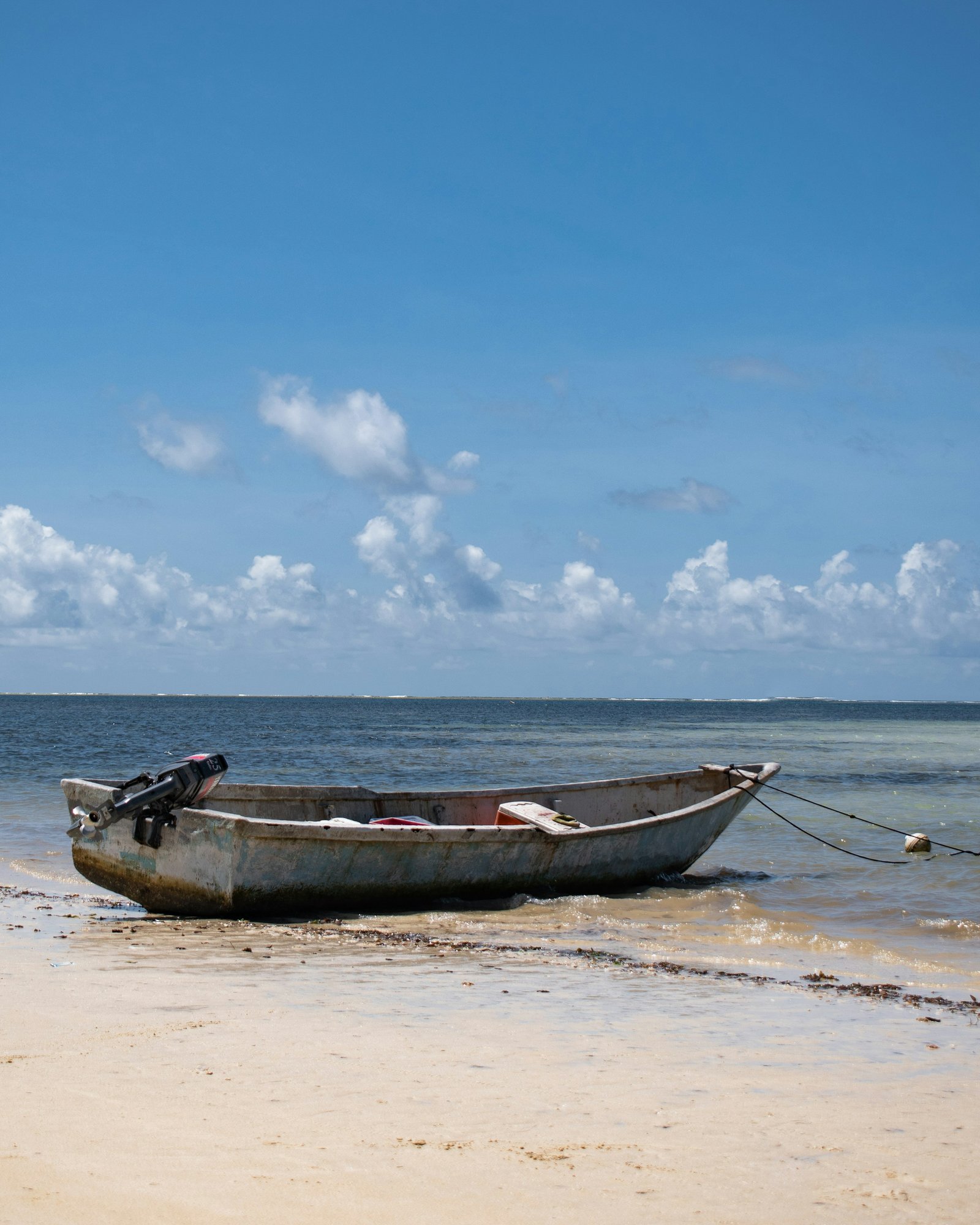 A traditional fishing boat resting on a Kenyan beach